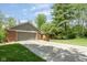 Lovely home exterior with a large garage, long driveway, and well-maintained lawn at 7420 Denton Cir, Indianapolis, IN 46256