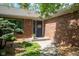 Charming brick home with a well-manicured entrance featuring a blue front door at 7420 Denton Cir, Indianapolis, IN 46256