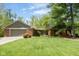 Charming brick home with a spacious front yard and mature landscaping, including a two-car garage at 7420 Denton Cir, Indianapolis, IN 46256