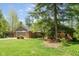 Beautiful brick home with a well-manicured lawn and mature trees, offers great curb appeal and charm at 7420 Denton Cir, Indianapolis, IN 46256