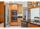Modern kitchen boasts stainless steel appliances, granite countertops, tile flooring and sleek cabinetry at 7420 Denton Cir, Indianapolis, IN 46256