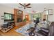 Cozy living room boasts brick fireplace, hardwood floors, and abundant natural light at 7420 Denton Cir, Indianapolis, IN 46256