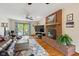 Inviting living room with brick fireplace, hardwood floors, and a view to patio at 7420 Denton Cir, Indianapolis, IN 46256