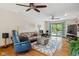 Spacious living room featuring hardwood floors, a plush sofa, and an entertainment area at 7420 Denton Cir, Indianapolis, IN 46256
