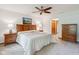 Comfortable bedroom with ceiling fan, soft lighting, and warm wooden furniture at 7420 Denton Cir, Indianapolis, IN 46256