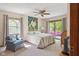 Carpeted primary bedroom with sliding glass doors to the backyard, and lots of natural light at 7420 Denton Cir, Indianapolis, IN 46256