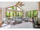 Bright sunroom with large windows, natural light, and a view to nature offers a peaceful spot to enjoy at 7420 Denton Cir, Indianapolis, IN 46256