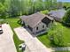 Aerial view of brick home showing landscaping, driveway and mature trees at 7665 Stones River Ct, Indianapolis, IN 46259