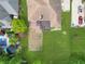 Overhead view of the home, including a large lawn, wooden deck, and an extended driveway at 7665 Stones River Ct, Indianapolis, IN 46259