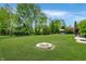 Sprawling backyard with a stone fire pit perfect for outdoor entertaining at 7665 Stones River Ct, Indianapolis, IN 46259