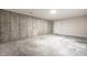 View of the unfinished basement with concrete walls and floor, offering potential for renovation at 7665 Stones River Ct, Indianapolis, IN 46259