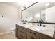 Bathroom featuring a double sink vanity with marble countertop, dark wood, and an arched window at 7665 Stones River Ct, Indianapolis, IN 46259