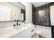 Modern bathroom with black subway tile shower and marble countertop sink at 7665 Stones River Ct, Indianapolis, IN 46259