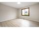 Bright bedroom with hardwood floors and natural light from the large window at 7665 Stones River Ct, Indianapolis, IN 46259