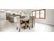 View of dining room and kitchen with stainless steel refrigerator and a wooden table with woven chairs at 7665 Stones River Ct, Indianapolis, IN 46259