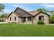 Charming single-story brick home with a well-manicured lawn and inviting front porch at 7665 Stones River Ct, Indianapolis, IN 46259