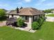 Beautiful home with a brown roof, light brick exterior, wooden deck and a well-maintained green lawn at 7665 Stones River Ct, Indianapolis, IN 46259