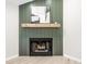 Modern fireplace with wood mantel and decorative paneling in a bright living space at 7665 Stones River Ct, Indianapolis, IN 46259