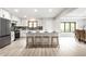 Modern kitchen with white cabinets, stainless steel appliances, and a large island at 7665 Stones River Ct, Indianapolis, IN 46259