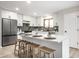 Bright kitchen featuring sleek appliances, white cabinetry and breakfast bar seating at 7665 Stones River Ct, Indianapolis, IN 46259