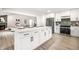 Open kitchen layout with quartz island, stainless appliances and open access to living area at 7665 Stones River Ct, Indianapolis, IN 46259