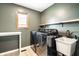 Well-equipped laundry room with new front-load washer and dryer at 7665 Stones River Ct, Indianapolis, IN 46259
