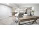 Open-concept living space with hardwood floors, desk, and a glimpse of the living room beyond at 7665 Stones River Ct, Indianapolis, IN 46259
