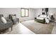 Cozy bedroom with decorative chairs, a bench, hardwood floors, and a view to the outside at 7665 Stones River Ct, Indianapolis, IN 46259