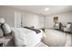 Bedroom featuring a large bed, hardwood floors, decorative chairs, and natural light at 7665 Stones River Ct, Indianapolis, IN 46259