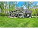 Large backyard view with patio seating and beautiful greenery, ideal for relaxation at 7716 Traders Hollow Ln, Indianapolis, IN 46278