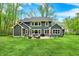 Expansive backyard featuring a patio with outdoor seating, barbecue, and lush green lawn at 7716 Traders Hollow Ln, Indianapolis, IN 46278