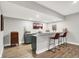 Finished basement bar with granite countertops, sink, barstool seating, and accent lighting at 7716 Traders Hollow Ln, Indianapolis, IN 46278
