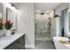 Luxurious bathroom with a double vanity, free-standing tub, and a walk-in shower with marble tiling at 7716 Traders Hollow Ln, Indianapolis, IN 46278