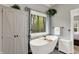 Elegant bathroom featuring a freestanding tub, large window with a view, and stylish fixtures and fittings at 7716 Traders Hollow Ln, Indianapolis, IN 46278