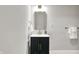 Well-lit bathroom featuring modern vanity with storage, brass fixtures, and neutral colors at 7716 Traders Hollow Ln, Indianapolis, IN 46278