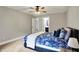 Spacious bedroom with plush carpeting, ceiling fan, and open doorway to an en-suite bathroom at 7716 Traders Hollow Ln, Indianapolis, IN 46278