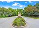 Community entrance to Traders Hollow with stone sign and landscaping at 7716 Traders Hollow Ln, Indianapolis, IN 46278