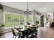 Inviting dining room with large windows offering scenic views of the lush backyard at 7716 Traders Hollow Ln, Indianapolis, IN 46278