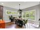 Bright dining room featuring a wooden table, bench seating, and natural light from large windows at 7716 Traders Hollow Ln, Indianapolis, IN 46278