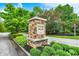 Elegant stone entrance sign for Traders Hollow community, set amidst landscaped greenery at 7716 Traders Hollow Ln, Indianapolis, IN 46278