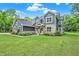 Spacious two-story home featuring a large lawn and lovely landscaping at 7716 Traders Hollow Ln, Indianapolis, IN 46278