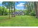 A two-story house on a large lot surrounded by tall, mature trees and a green lawn at 7716 Traders Hollow Ln, Indianapolis, IN 46278