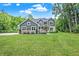 Lovely two-story home with lush front lawn and landscaped flower beds at 7716 Traders Hollow Ln, Indianapolis, IN 46278