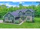 Beautiful two-story home with stone accents and landscaped front yard on a sunny day at 7716 Traders Hollow Ln, Indianapolis, IN 46278