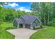 A large two-car garage attached to a beautiful two-story home surrounded by lush greenery at 7716 Traders Hollow Ln, Indianapolis, IN 46278