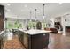 Gourmet kitchen with large island, stainless appliances, and open concept layout at 7716 Traders Hollow Ln, Indianapolis, IN 46278
