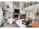 Comfortable living room featuring a stone fireplace and open staircase to a second floor at 7716 Traders Hollow Ln, Indianapolis, IN 46278