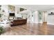 Spacious living room with hardwood floors, stone fireplace, and open access to the second floor at 7716 Traders Hollow Ln, Indianapolis, IN 46278