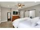 Cozy bedroom with natural light, dresser, and a glimpse into the ensuite bathroom at 7716 Traders Hollow Ln, Indianapolis, IN 46278