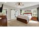 Spacious main bedroom featuring a barn door leading to an ensuite bathroom, with ample natural light at 7716 Traders Hollow Ln, Indianapolis, IN 46278